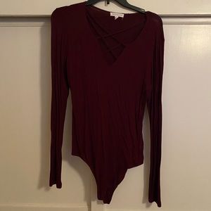Burgundy long sleeved bodysuit with snap closure